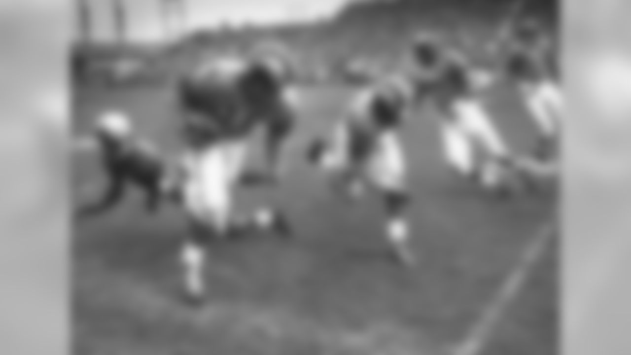 Los Angeles Rams Hall of Fame defensive back Dick "Night Train" Lane levels a devastating block on Green Bay Packers end Bob Mann (87) to help spring Rams back Woodley Lewis (20) during a 38-20 Rams victory on October 11, 1953, at Milwaukee County Stadium. (National Football League)