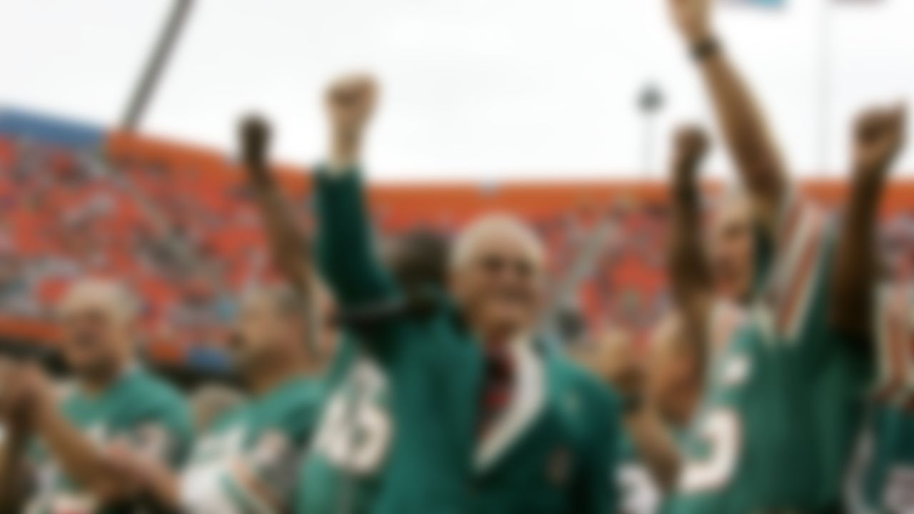 Former Miami Dolphins coach Don Shula, center, waves with former players from the 1972 unbeaten team during a ceremony at an NFL football game at Dolphin Stadium in Miami From left are running back Larry Csonka (39), center Jim Langer (62) and linebacker Nick Buoniconti, right. Pro Football Hall of Fame center Jim Langer, who was literally in the middle of the Miami Dolphins' 1972 perfect season, has died at the age of 71. Langer died Thursday, Aug. 29, 2019, at a Coon Rapids, Minnesota hospital near his home of a sudden heart-related problem, said his wife, Linda.