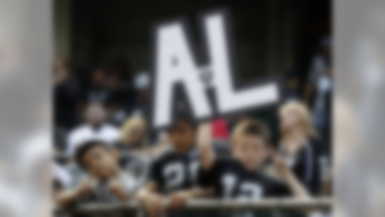 Oakland Raiders fan Richie de la Paz, 9, holds up a sign in honor of Al Davis, the late owner of the team, before the Raiders' NFL football game against the Cleveland Browns in Oakland, Calif., Sunday, Oct. 16, 2011. (AP Photo/Paul Sakuma)