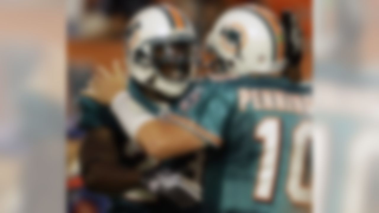 Miami Dolphins running back Ronnie Brown, left, celebrates a touchdown with quarterback Chad Pennington in the first quarter of a preseason NFL football game against the Carolina Panthers in Miami, Fla., Saturday, Aug. 22, 2009. (AP Photo/Lynne Sladky).