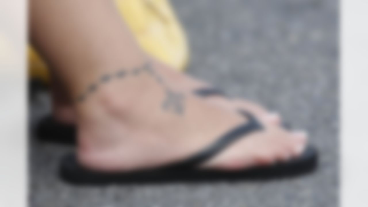 A fan sports a tattoo of bearing the logo of the New Orleans Saints football team at the club's football training camp in Metairie, LA., Tuesday, Aug. 4, 2009. (AP Photo/Bill Haber)