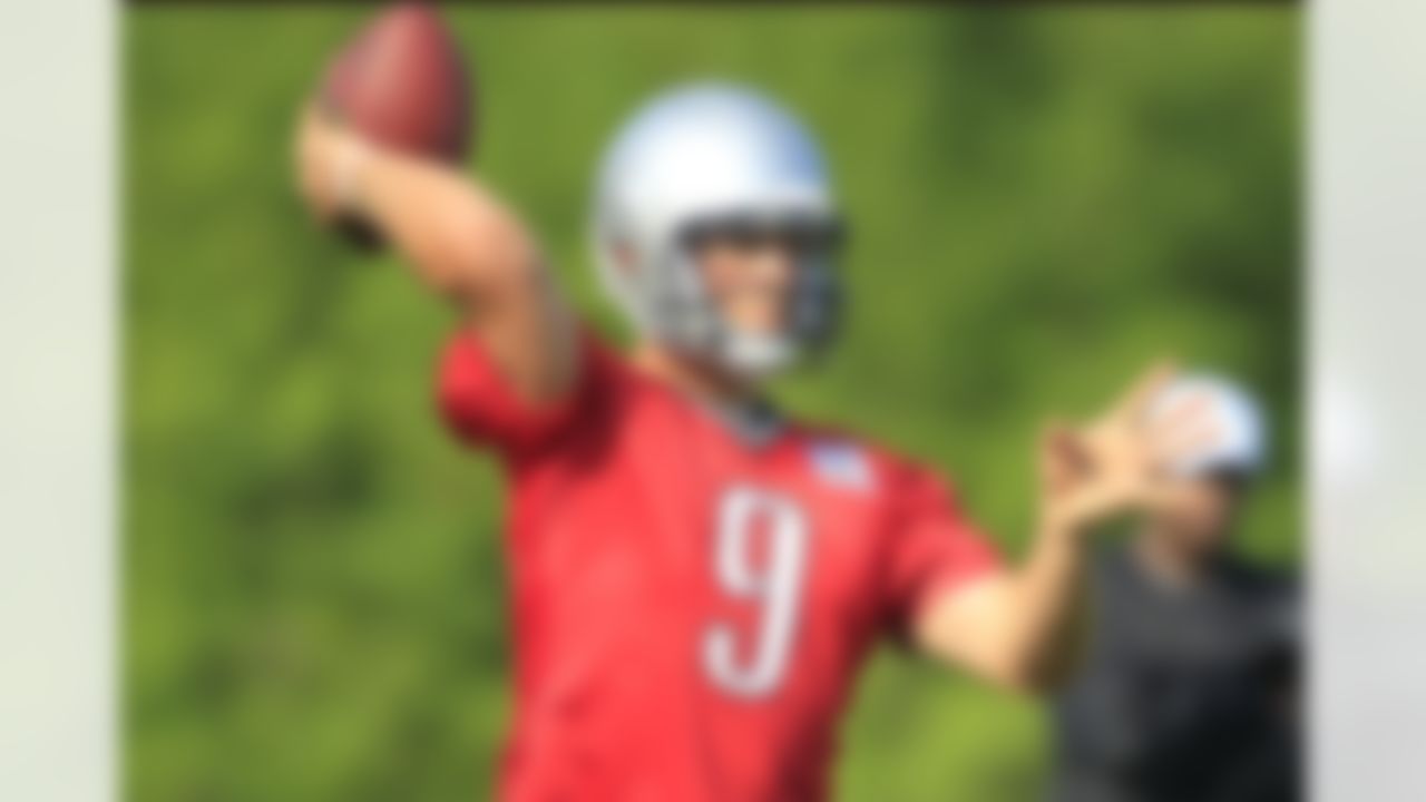 Detroit Lions quarterback Matthew Stafford warms up during NFL football training camp in Allen Park, Mich. Monday, July 30, 2012. (AP Photo/Carlos Osorio)