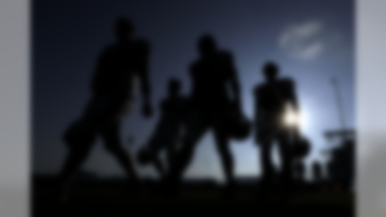 Houston Texans' players walks across a practice field before the start of a joint NFL training camp football practice with the Detroit Lions on Thursday, Aug. 15, 2019, in Houston.