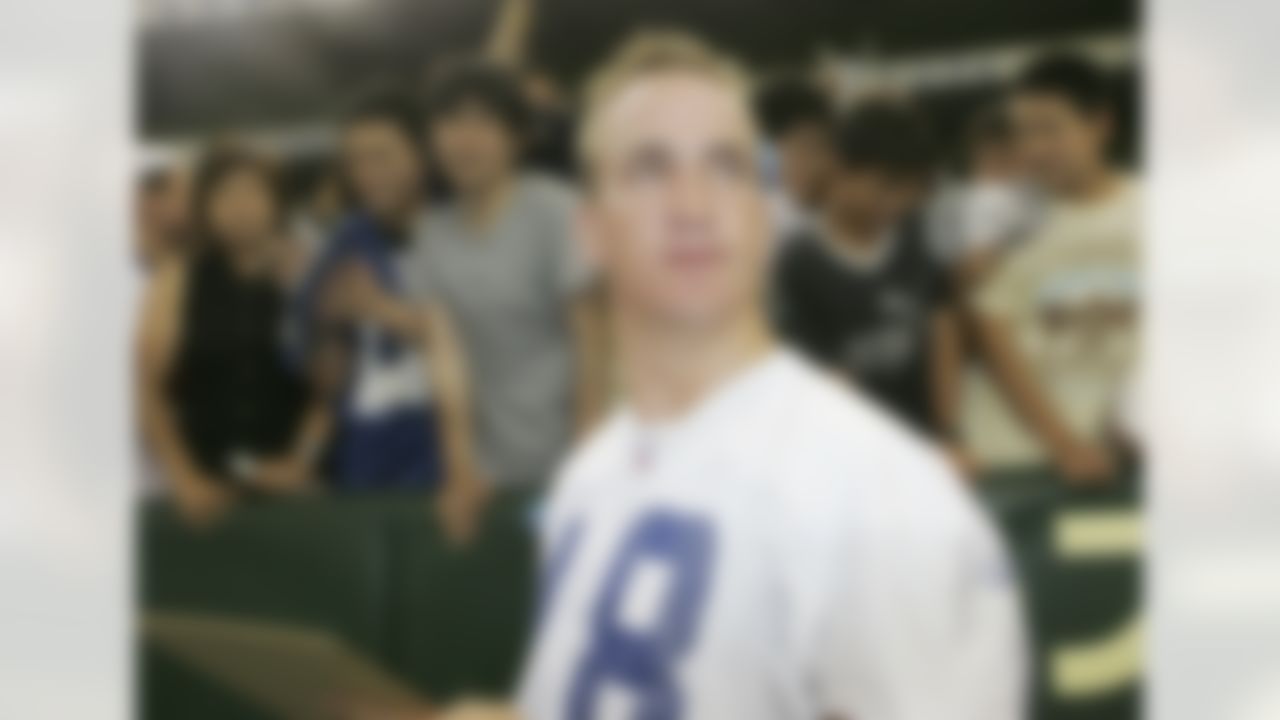 TOKYO, JAPAN- AUGUST 5: Quarterback Peyton Manning #18 of the Indianapolis Colts communicates with Japanese fans during a public workout at Tokyo Dome on August 5, 2005 in Tokyo, Japan. The Indianapolis Colts will play against the Atlanta Falcons in the American Bowl on August 6. (Photo by Koichi Kamoshida/Getty Images)