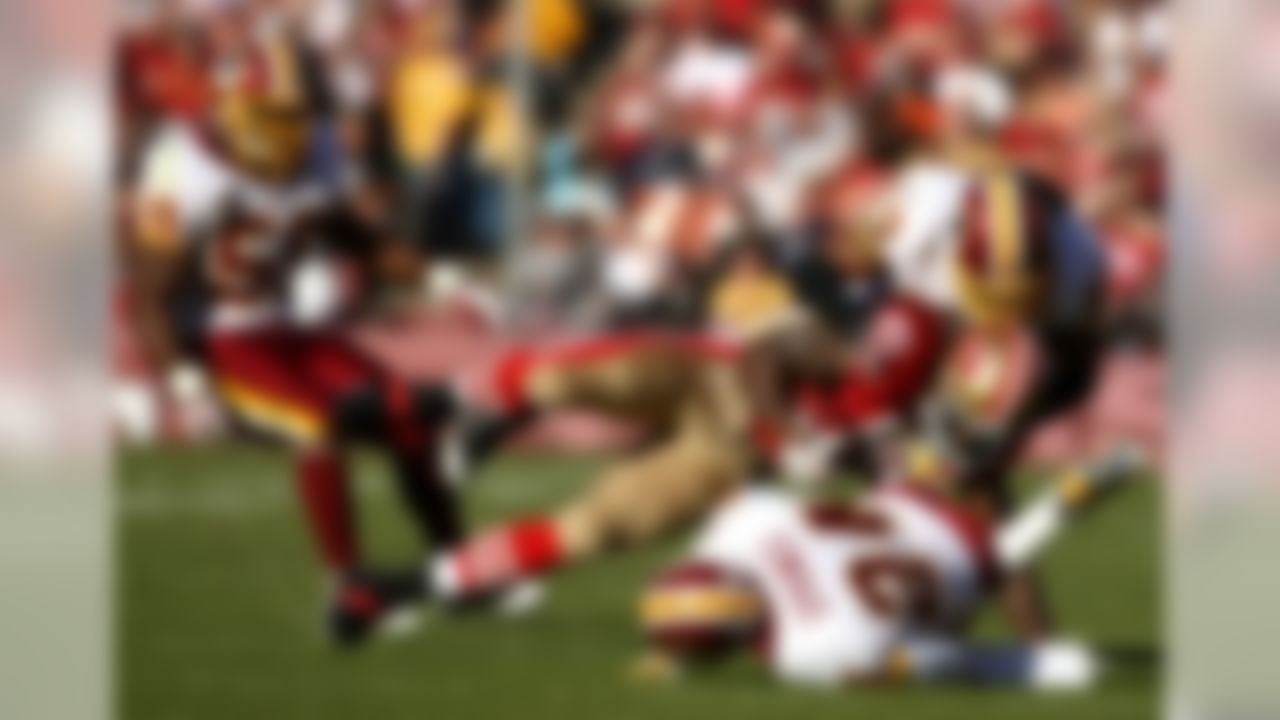 SAN FRANCISCO - DECEMBER 28:  Vernon Davis #85 of the San Francisco 49ers is tackled by Shawn Springs #24 and Marcus Washington #53 of the Washington Redskins at Candlestick Park on December 28, 2008 in San Francisco, California  (Photo by Jonathan Ferrey/Getty Images)