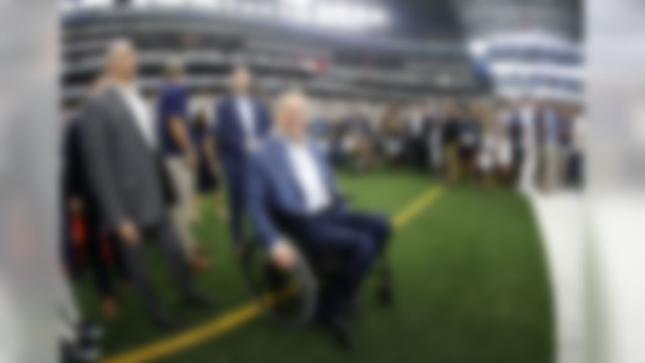 Texas Governor Greg Abbott, center, watches warmups before an NFL football game between the Green Bay Packers and the Dallas Cowboys in Arlington, Texas, Sunday, Oct. 6, 2019. (AP Photo/Ron Jenkins)