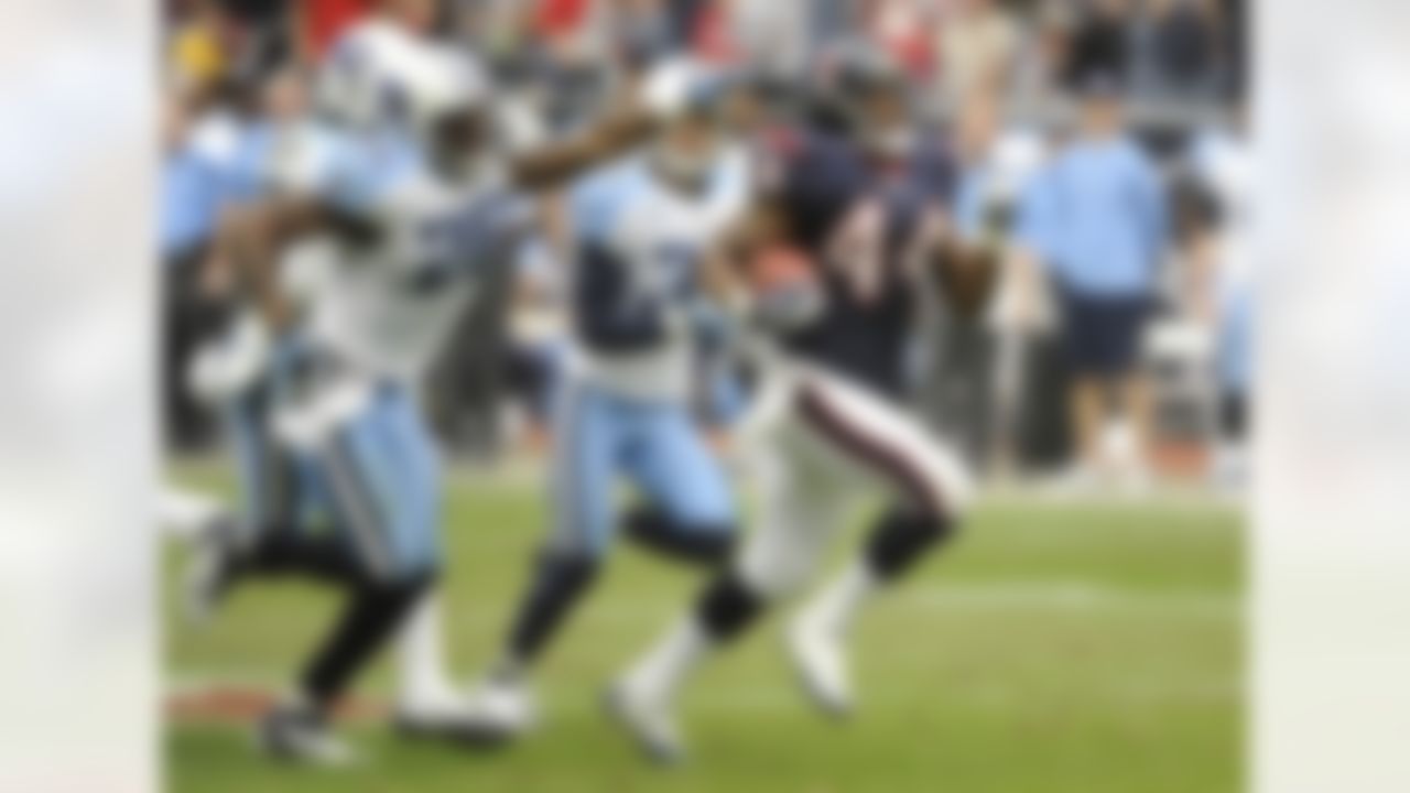 Houston Texans running back Ben Tate (44) and Tennessee Titans cornerback Cortland Finnegan (31) and  Jordan Babineaux (26) in the third quarter of an NFL football game Sunday, Jan. 1, 2012, in Houston. (AP Photo/Dave Einsel)