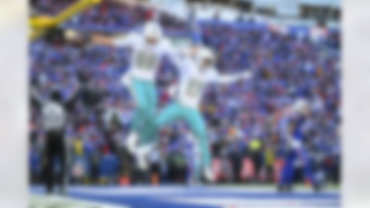 Miami Dolphins tight end Mike Gesicki (88) celebrates with wide receiver Jaylen Waddle (17) after scoring a touchdown during an NFL Super Wild Card Weekend playoff game against the Buffalo Bills on Sunday, January 15, 2023 in Orchard Park, New York.