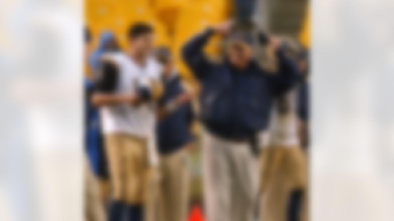 St. Louis Rams quarterback Marc Bulger (10) relaxes on the sideline with coach Mike Martz in the fourth quarter of the Rams' 33-21 win over the Pittsburgh Steelers on Sunday, Oct. 26, 2003, in Pittsburgh. (AP Photo/Carolyn Kaster)