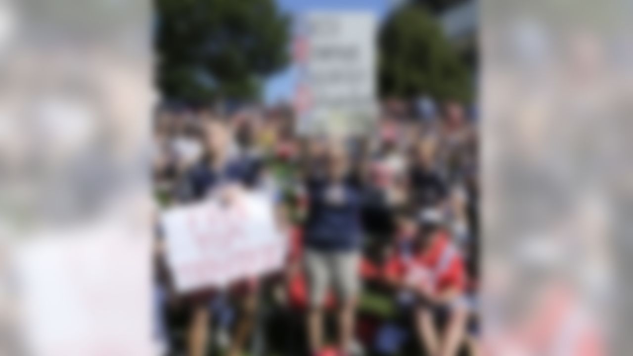 A New England Patriots fans hold a signs supporting quarterback Tom Brady while seated with thousands to watch practice during an NFL football training camp in Foxborough, Mass., Friday, July 31, 2015. (AP Photo/Charles Krupa)