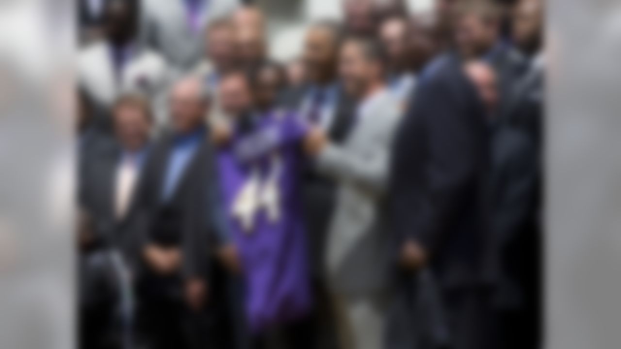 President Barack Obama and Baltimore Ravens head coach John Harbaugh, center, hold a Baltimore Ravens football jersey presented to the president during a ceremony on the South Lawn of the White House in Washington, Wednesday, June 5, 2013, where the president honored the Super Bowl XLVII champs. The Ravens defeated the San Francisco 49ers in Super Bowl XLVII. General Manager Ozzie Newsome is at right. (AP Photo/Evan Vucci)