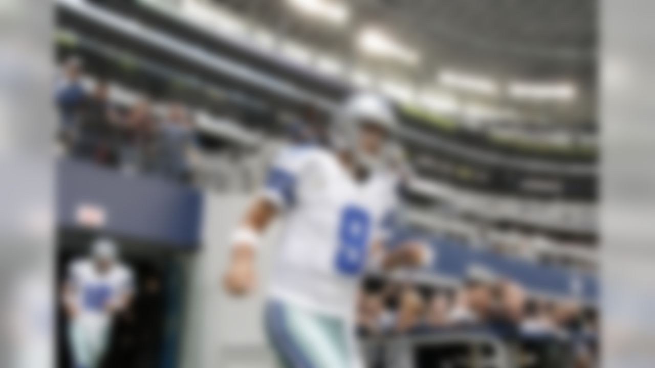 Dallas Cowboys' quarterbacks Tony Romo (9) and Kyle Orton (18) run out of the tunnel an onto the field for warm ups before an NFL football game against the Cleveland Browns Sunday, Nov. 18, 2012 in Arlington, Texas. (AP Photo/Brandon Wade)