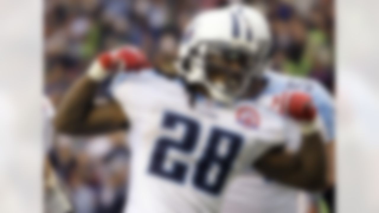 Tennessee Titans' Chris Johnson celebrates his touchdown in the fourth quarter against the Seattle Seahawks, Sunday, Jan. 3, 2010, during an NFL football game in Seattle. On Sunday, Johnson became the sixth player in NFL history to rush for 2,000 yards in a season. (AP Photo/Elaine Thompson)