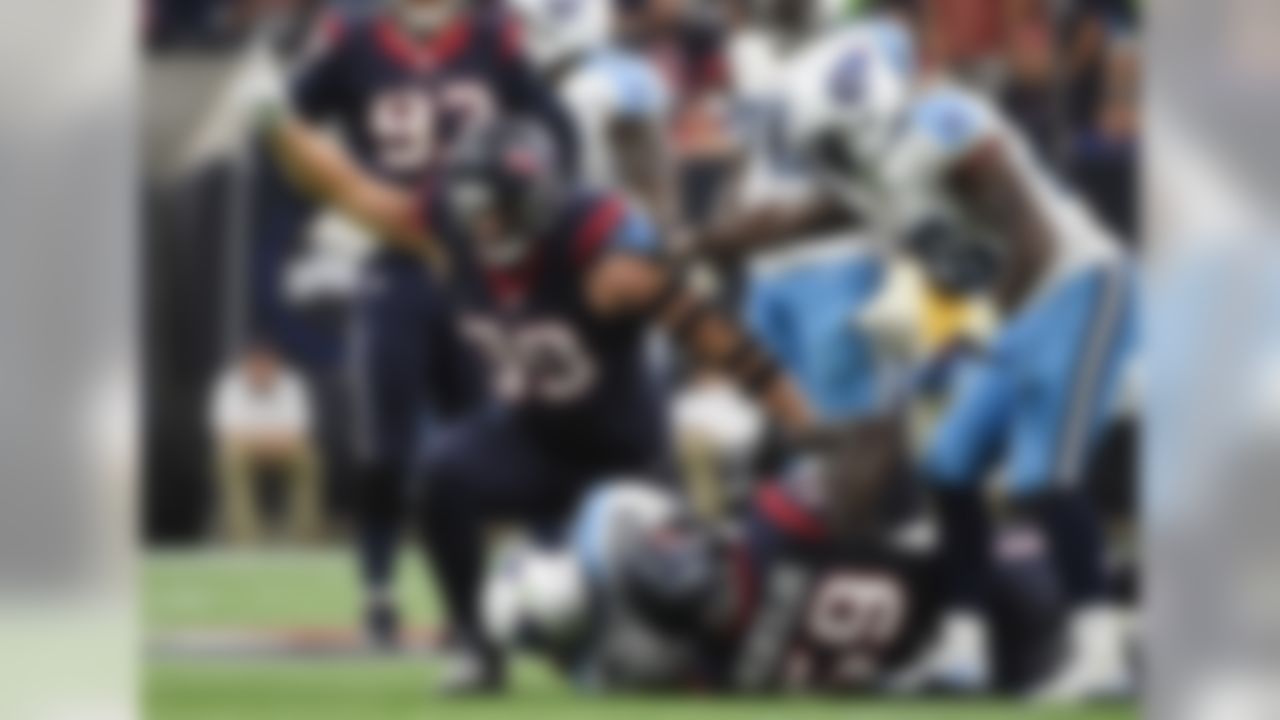 Houston Texans defensive end J.J. Watt (99) celebrates after he outside linebacker Whitney Mercilus (59) sacked Tennessee Titans quarterback Zach Mettenberger (7) during the second half of an NFL football game, Sunday, Nov. 1, 2015, in Houston. (AP Photo/Eric Christian Smith)