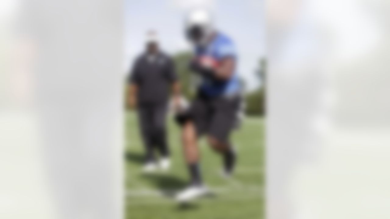 Detroit Lions wide receiver Stefan Logan runs through an agility drill under the watch of running backs coach Sam Gash, left, during an NFL football training camp Saturday, July 28, 2012, in Allen Park, Mich. (AP Photo/Duane Burleson)