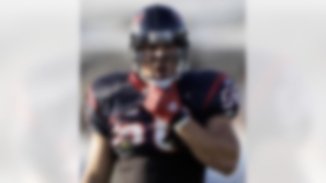 Houston Texans linebacker Brian Cushing adjusts his chinstrap during an NFL football training camp practice Sunday, Aug. 1, 2010, in Houston. (AP Photo/David J. Phillip)