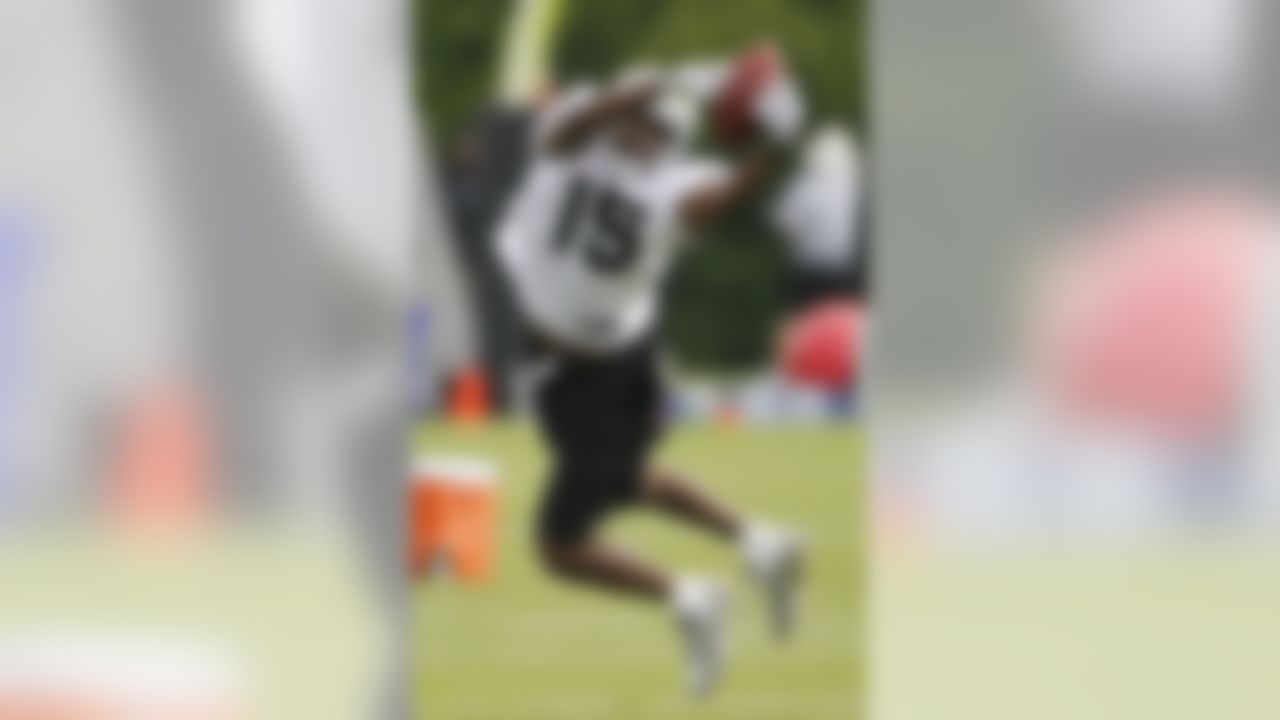 Oakland Raiders wide receiver Johnnie Lee Higgins reaches for a pass during football training camp in Napa, Calif., Thursday, July 29, 2010. (AP Photo/Eric Risberg)