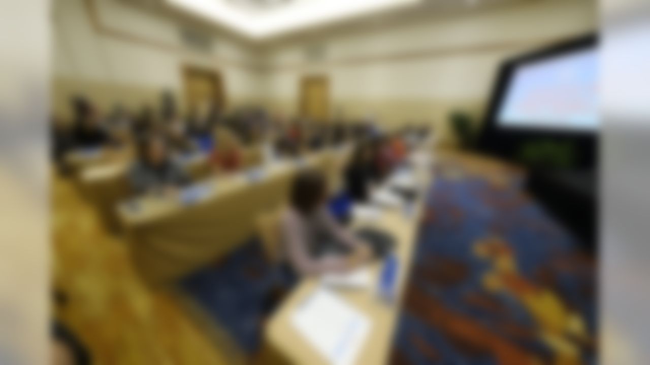 Female participants take notes during the panel discussion at the NFL Women's Forum held in Indianapolis, Tuesday, Feb. 26, 2019.