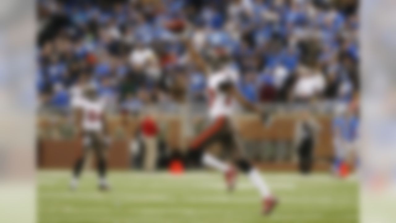 Tampa Bay Buccaneers cornerback Johnthan Banks (27) runs back to the sidelines after intercepting a pass intended for Detroit Lions wide receiver Calvin Johnson (81) during the fourth quarter of an NFL football game in Detroit, Sunday, Nov. 24, 2013. (AP Photo/Paul Sancya)