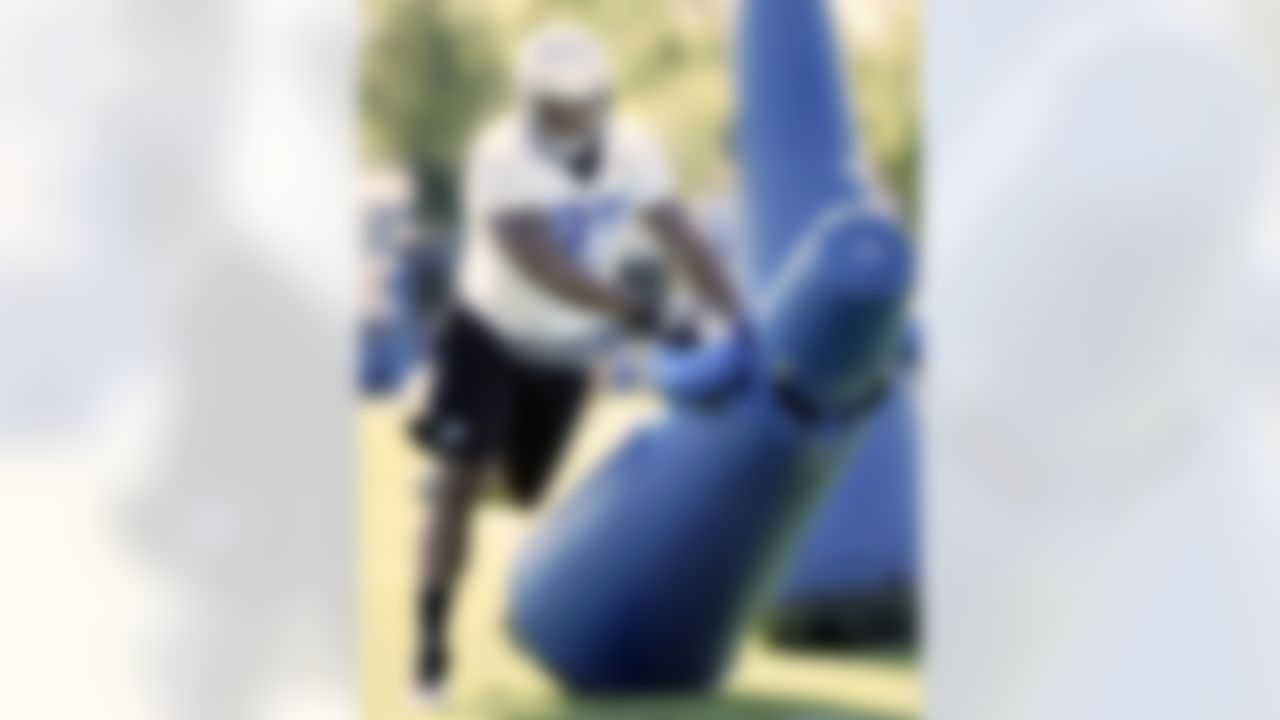 Detroit Lions rookie defensive end Ronnell Lewis hits a tackling dummy during NFL football training camp on Sunday, July 29, 2012, in Allen Park, Mich. (AP Photo/Duane Burleson)