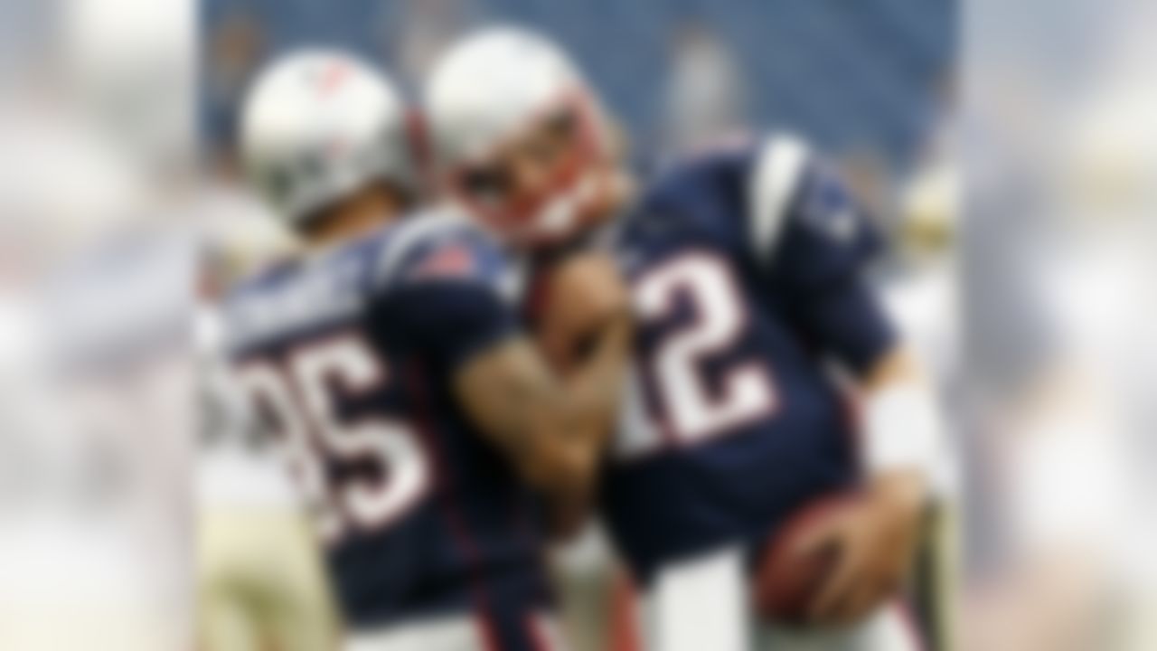 New England Patriots'  Tom Brady (12) bumps helmets with rookie Aaron Hernandez before an NFL preseason football game against the New Orleans Saints in Foxborough, Mass., Thursday, Aug. 12, 2010. (AP Photo/Winslow Townson)