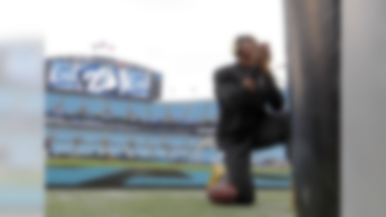 Carolina Panthers quarterback Cam Newton pauses by a goal post as he warms up before an NFL football game against the Detroit Lions in Charlotte, N.C., Sunday, Sept. 14, 2014. (AP Photo/Bob Leverone)