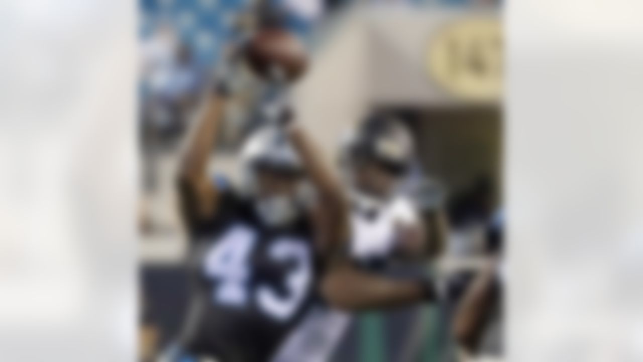 A pass slips through the hands of Carolina Panthers running back Fozzy Whittaker (43) as he is defended by Jacksonville Jaguars defensive lineman Malik Jackson during the first half of an NFL preseason football game, Thursday, Aug. 24, 2017, in Jacksonville, Fla. (AP Photo/Stephen B. Morton)