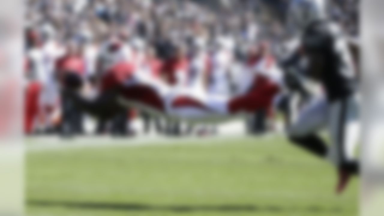 Arizona Cardinals wide receiver Jaron Brown catches a pass in front of Oakland Raiders cornerback T.J. Carrie (38) during the first quarter of an NFL football game in Oakland, Calif., Sunday, Oct. 19, 2014. (AP Photo/Ben Margot)