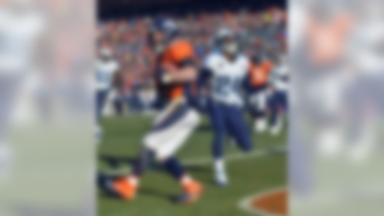 Denver Broncos wide receiver Wes Welker, left, scores past Tennessee Titans cornerback Coty Sensabaugh during the first half of an NFL football game on Sunday, Dec. 8, 2013, in Denver. (AP Photo/Jack Dempsey)