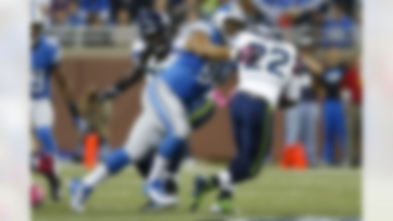 Detroit Lions defensive tackle Ndamukong Suh (90) tackles Seattle Seahawks running back Robert Turbin (22) during an NFL football game, Sunday, Oct. 28, 2012. in Detroit. (AP Photo/Rick Osentoski)