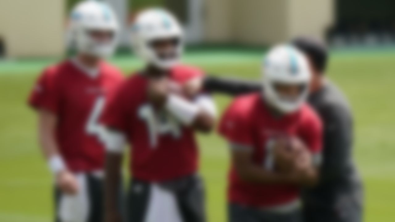 Miami Dolphins quarterbacks Tua Tagovailoa, right, Jacoby Brissett, center, and Reid Sinnett, left, run drills during a mandatory minicamp at the NFL football team's training camp, Tuesday, June 15, 2021, in Davie, Fla.