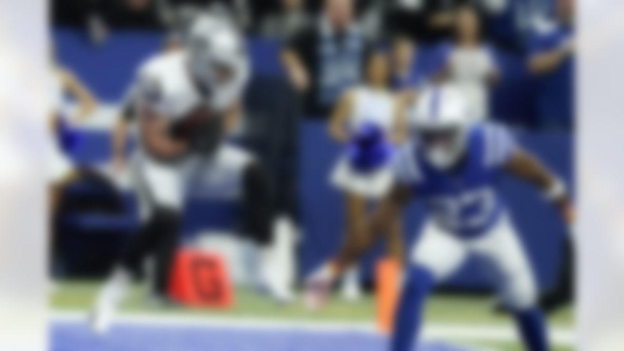 Las Vegas Raiders wide receiver Hunter Renfrow (13) catches an 11-yard touchdown pass ahead of Indianapolis Colts cornerback Kenny Moore II (23) during the second half of an NFL football game, Sunday, Jan. 2, 2022, in Indianapolis.