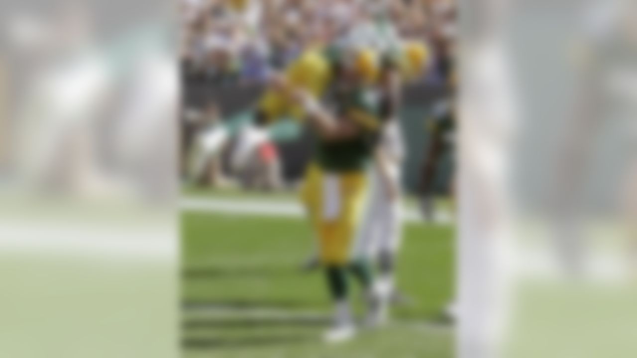 Green Bay Packers quarterback Brett Favre lifts Donald Driver after throwing a touchdown pass to Greg Jennings during the second half of an NFL football game against the San Diego Chargers Sunday, Sept. 23, 2007, in Green Bay, Wis. The touchdown pass tied Dan Marino's all-time NFL record for career TD passes at 420 and rallied the Packers past the San Diego Chargers on their way to a 31-24 victory. Photo by Morry Gash/AP.