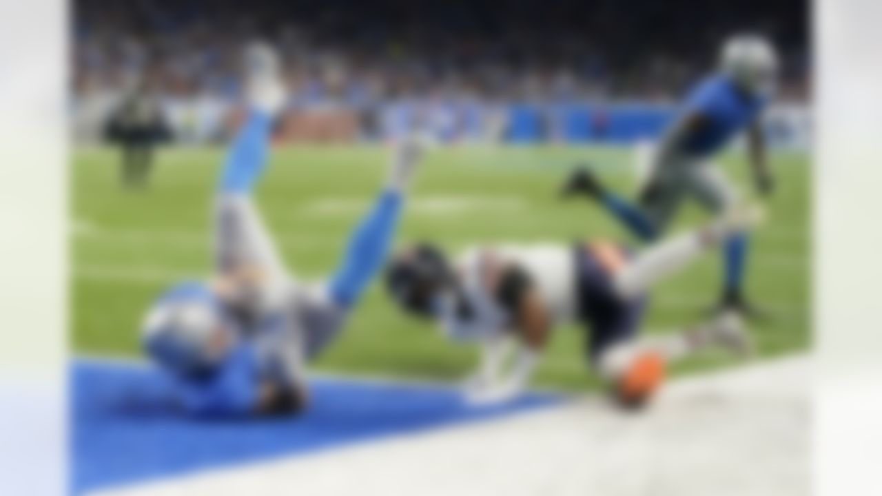 Detroit Lions tight end Brock Wright, defended by Chicago Bears safety Jaquan Brisker, falls into the end zone for a touchdown during the first half of an NFL football game, Sunday, Jan. 1, 2023, in Detroit.