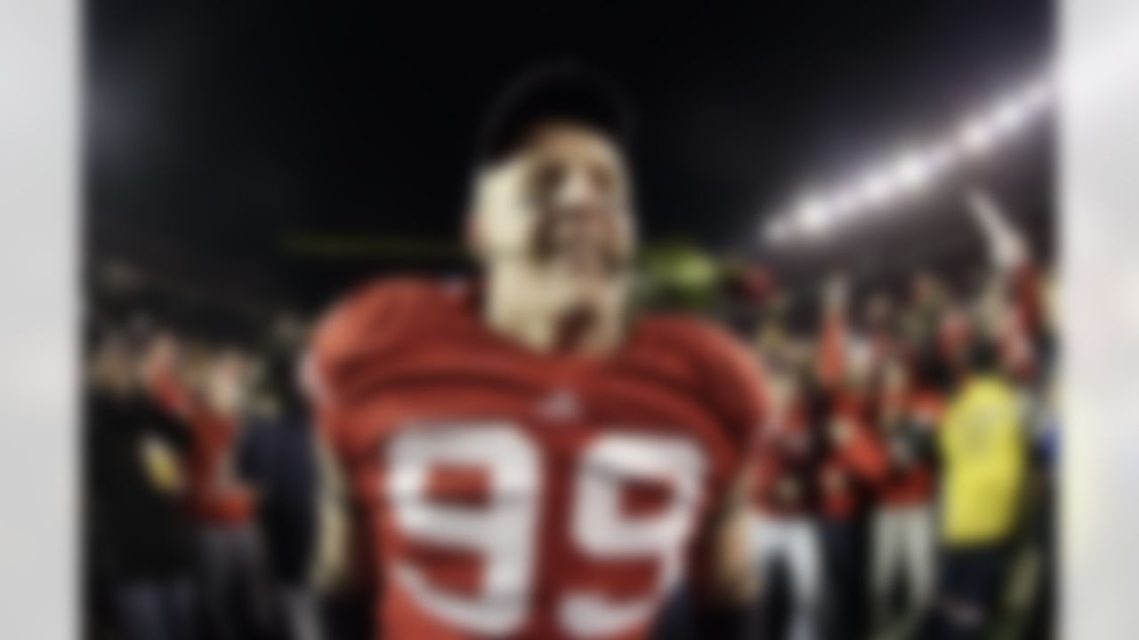 Wisconsin defensive tackle J.J. Watt bites a rose after an NCAA college football game against Northwestern Saturday, Nov. 27, 2010, in Madison, Wis. Wisconsin won 70-23. Wisconsin (11-1, 7-1 Big Ten) has the inside track on a Rose Bowl berth, which will be determined by the Bowl Championship Series standings. (AP Photo/Morry Gash)