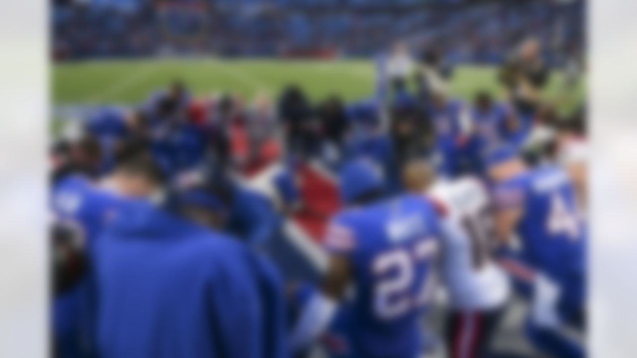 New England Patriots and Buffalo Bills players kneel after an NFL football game on Sunday, January 8, 2023 in Orchard Park, New York.