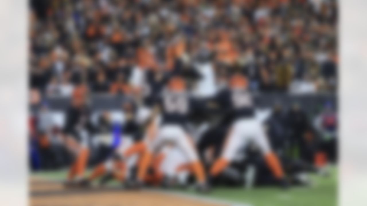 Baltimore Ravens quarterback Tyler Huntley (2) is blocked from reaching the end zone by Cincinnati Bengals linebacker Logan Wilson (55) during an NFL Super Wild Card Weekend playoff game on Sunday, January 15, 2023 in Cincinnati, Ohio.