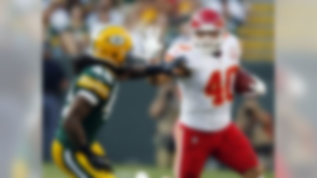 Kansas City Chiefs' Peyton Hillis (40) tries to break away from Green Bay Packers' Morgan Burnett (42) during the first half of an NFL preseason football game Thursday, Aug. 30, 2012, in Green Bay, Wis. (AP Photo/Tom Lynn)