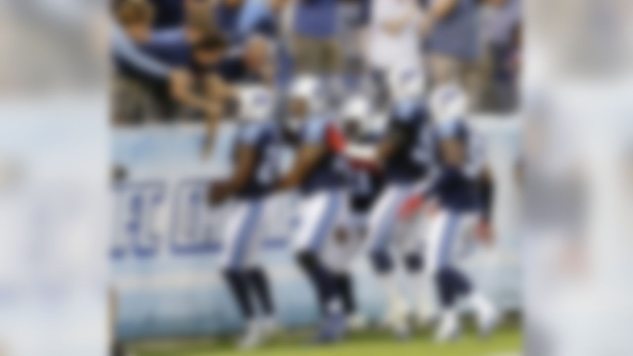 Tennessee Titans defensive back Perrish Cox (29) celebrates with teammates and fans after intercepting a pass against the St. Louis Rams and running it back for a touchdown during the first half of a preseason NFL football game Sunday, Aug. 23, 2015, in Nashville, Tenn. (AP Photo/James Kenney)