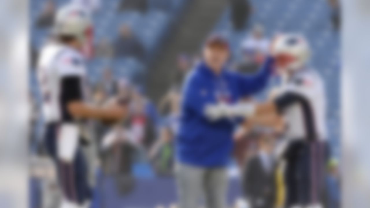 Former Buffalo Bills quarterback Jim Kelly, center, talks to New England Patriots quarterback Brian Hoyer, right, and quarterback Tom Brady prior to an NFL football game, Sunday, Dec. 3, 2017, in Orchard Park, N.Y. (AP Photo/Adrian Kraus)