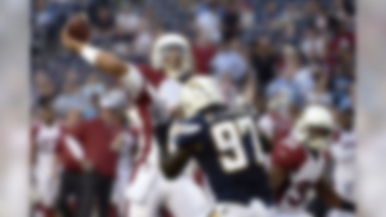 Arizona Cardinals quarterback Logan Thomas throws a pass over San Diego Chargers outside linebacker Jeremiah Attaochu (97) during the first half of an NFL preseason football game Thursday, Aug. 28, 2014, in San Diego. (AP Photo/Denis Poroy)