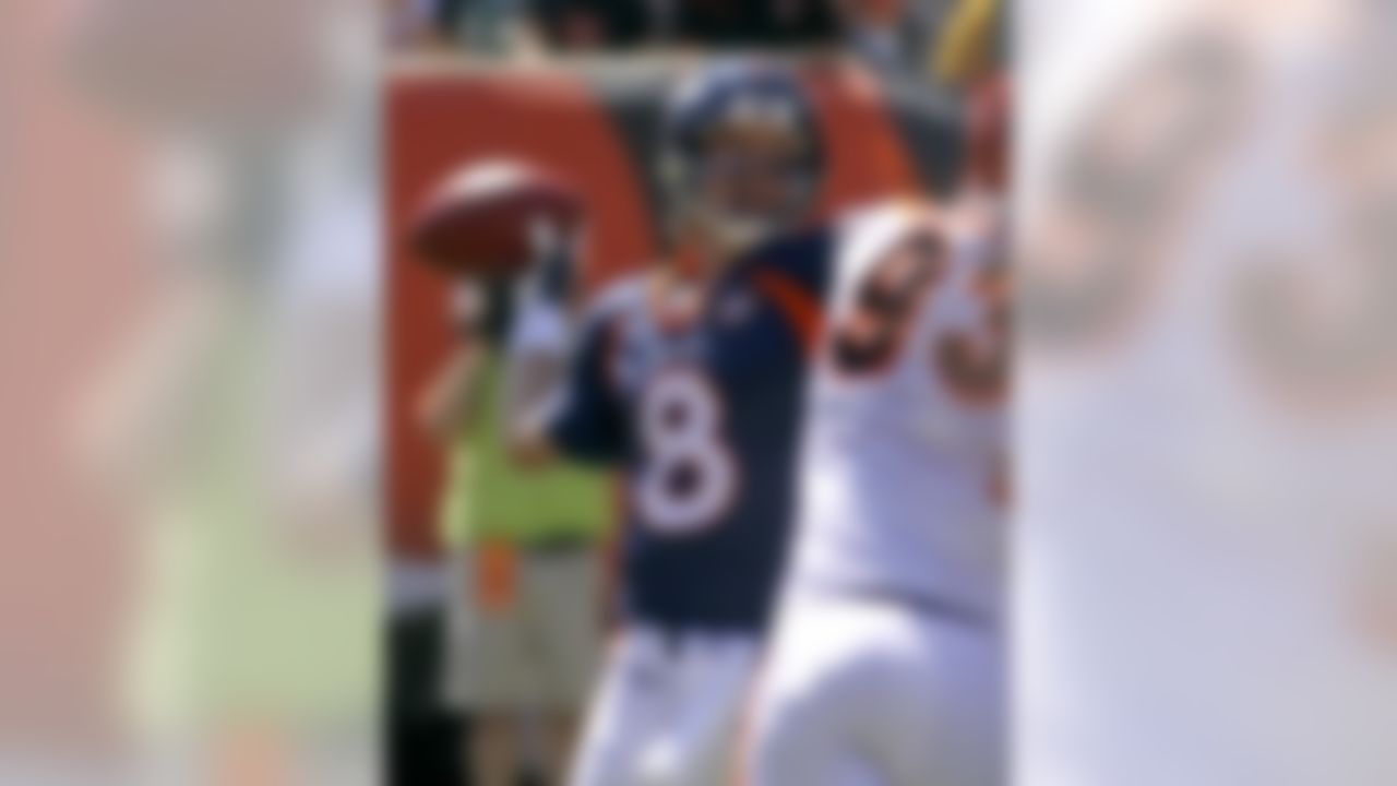 Denver Broncos quarterback Kyle Orton (8) passes under pressure from Cincinnati Bengals defensive end Michael Johnson (93) in the first half of an NFL football game, Sunday, Sept. 13, 2009, in Cincinnati. (AP Photo/Tom Uhlman)