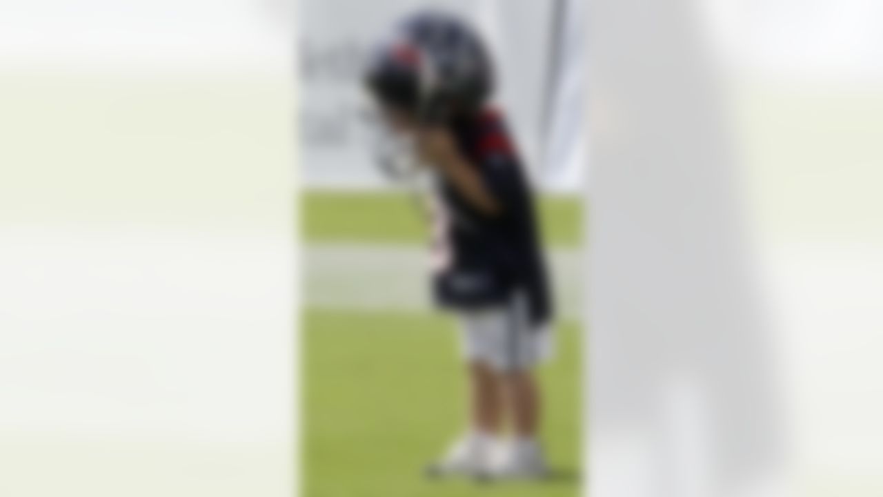 Burke Brown, 2, son of Houston Texans kicker Kris Brown, tries on his dad's helmet after the team's first NFL training camp practice of the season Friday, July 30, 2010 in Houston. (AP Photo/David J. Phillip)