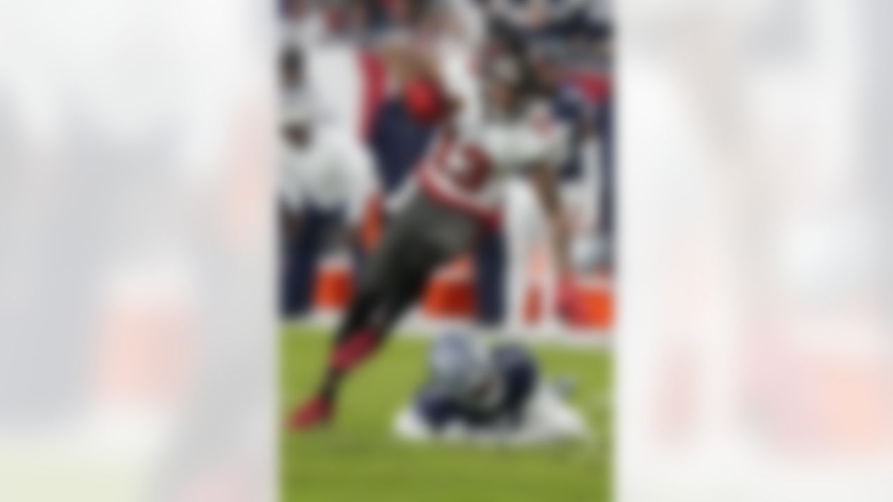 Tampa Bay Buccaneers wide receiver Mike Evans (13) runs by Dallas Cowboys cornerback Trevon Diggs (7) during the first half of an NFL wild-card football game, Monday, Jan. 16, 2023, in Tampa, Fla.