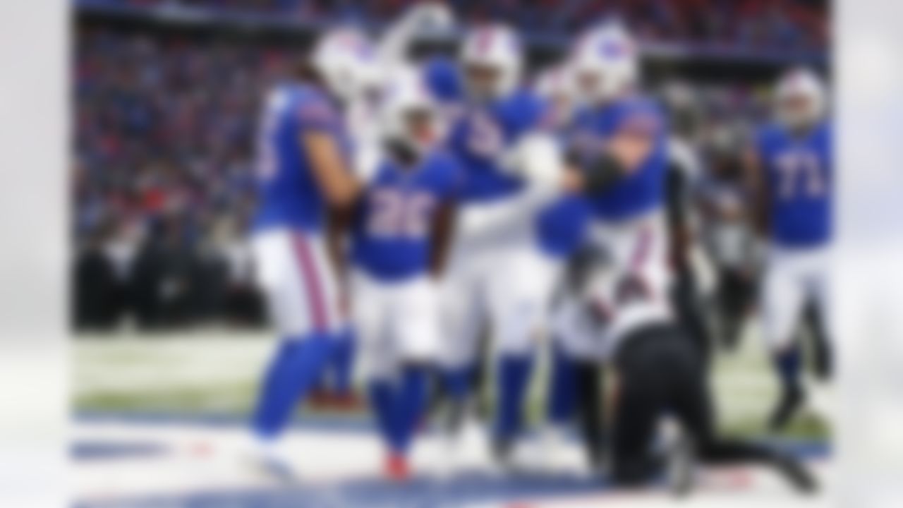 Atlanta Falcons cornerback Darren Hall (34) reacts as Buffalo Bills' Devin Singletary (26) celebrates with teammates after scoring a touchdown during the second half of an NFL football game Sunday, Jan. 2, 2022, in Orchard Park, N.Y. The Bills won 29-15.