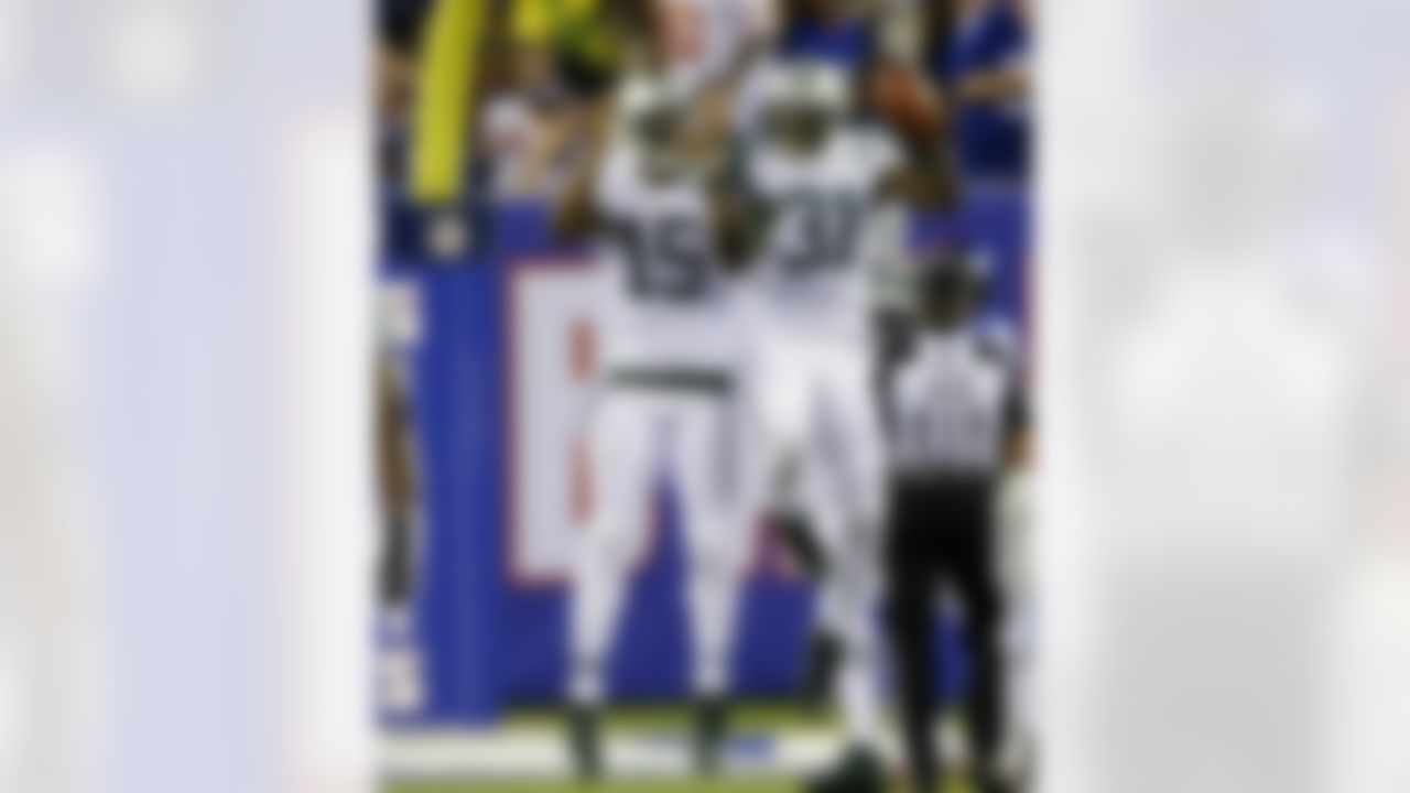 New York Jets defensive back Antonio Cromartie (31) and Brandon Marshall (15) celebrate after Cromartie scored a touchdown on an interception during the first half of a preseason NFL football game against the New York Giants, Saturday, Aug. 29, 2015, in East Rutherford, N.J. (AP Photo/Seth Wenig)
