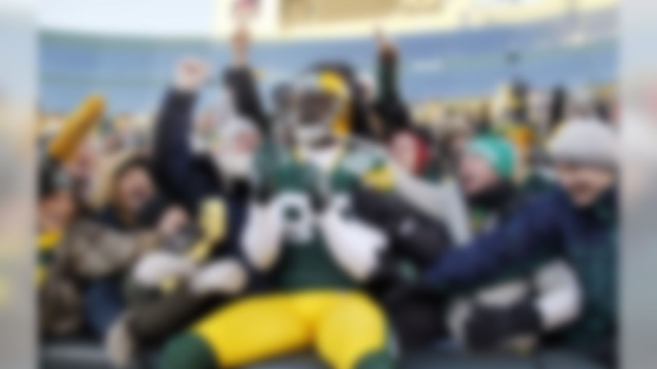 Green Bay Packers' James Jones celebrates with fans after catching a 3-yard touchdown pass during the first half of an NFL football game against the New York Giants on Sunday, Dec. 26, 2010, in Green Bay, Wis. (AP Photo/Jeffrey Phelps)