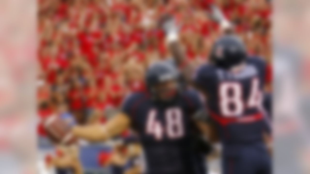 Arizona's Rob Gronkowski (48) is congratulated by teammate Terrell Turner (84) after scoring a touchdown against Washington during the first half of an NCAA college football in Tucson, Ariz., Saturday, Oct. 4, 2008.