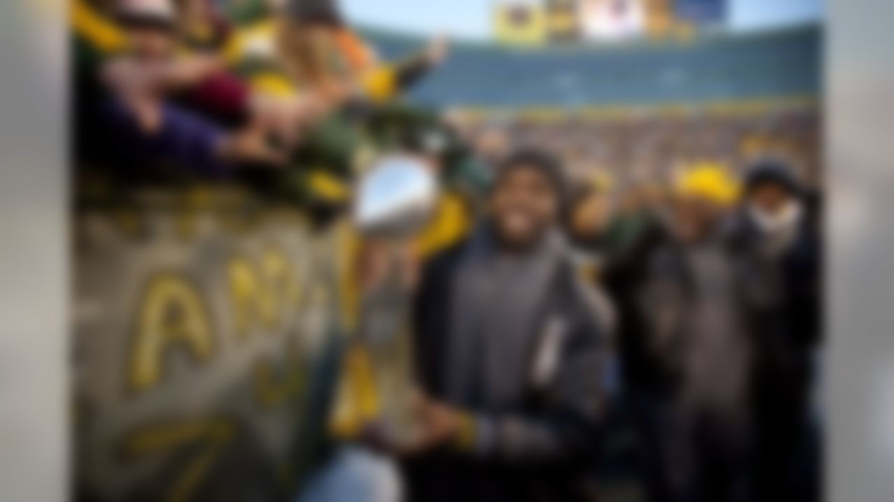 With other members of the team following behind him, Green Bay Packers safety Nick Collins holds the Vince Lombardi trophy as he walks around the stadium and celebrates with fans during the "Return to Titletown" celebration Tuesday, Feb. 8, 2011, at Lambeau Field in Green Bay, Wis.  The Packers defeated the Pittsburgh Steelers 31-25 in NFL football's Super Bowl XLV on Sunday, Feb. 6. (AP Photo/Mike Roemer)