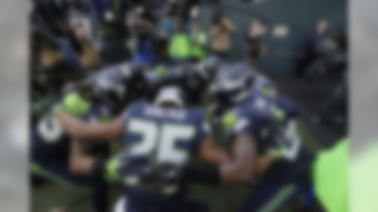 The Seattle Seahawks "Legion of Boom" defensive players including strong safety DeShawn Shead (35) huddle before taking the field for warmups before an NFL football game against the Arizona Cardinals, Sunday, Nov. 23, 2014, in Seattle. (AP Photo/Elaine Thompson)